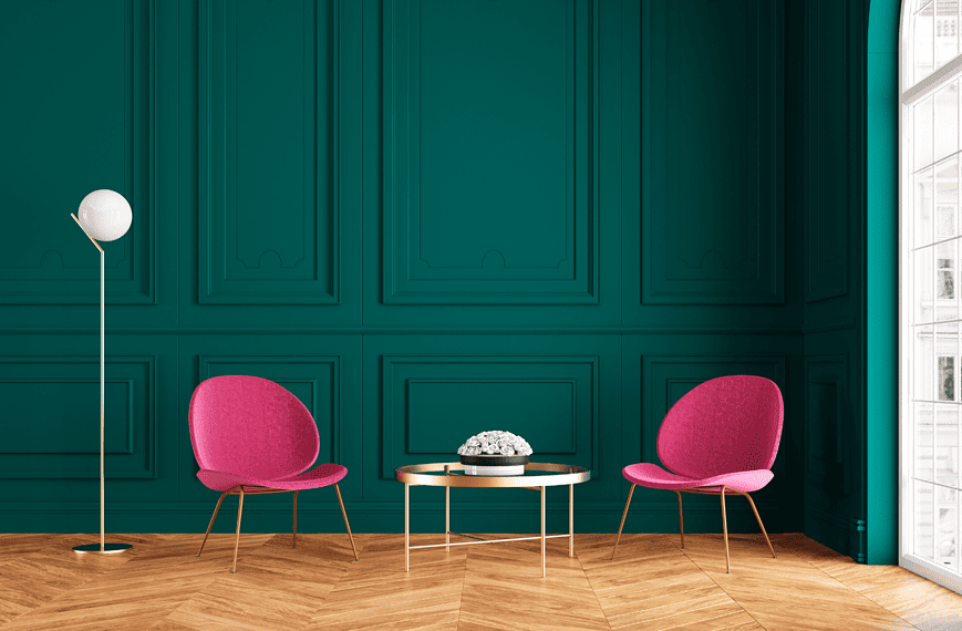 Une pièce aux murs verts et aux chaises roses meublées de lampes de table design.